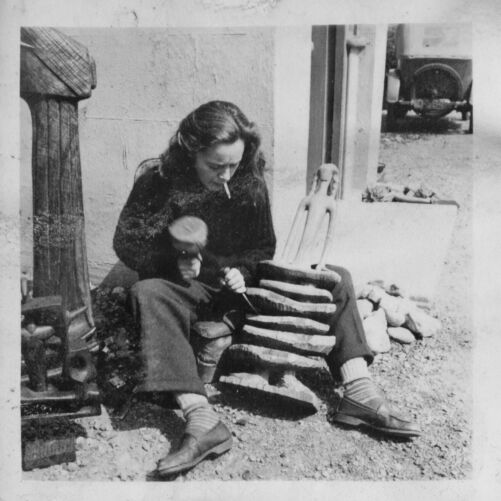 Hilary Heron carving Lady of the Rocks, 1953; image courtesy of IMMA and the Estate of Hilary Heron.⁠